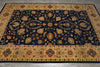 Load image into Gallery viewer, A rectangular area rug with an intricate traditional floral pattern, featuring a dark navy blue center field and ornate beige borders with gold, orange, and green accents.