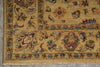 Load image into Gallery viewer, A close-up of an ornate traditional area rug with a warm beige and ochre base, featuring intricate floral and botanical motifs in muted red, blue, green, and brown, finished with a fringed edge.