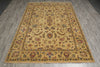 Load image into Gallery viewer, A rectangular vintage-style area rug with an intricate floral and medallion pattern in beige, brown, and muted blue, laid out on a gray wood-look floor.