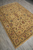Load image into Gallery viewer, A rectangular vintage-style area rug with an intricate floral and paisley pattern in warm beige, gold, brown, and muted blue tones, laid out on a gray wood-look floor.