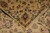 Load image into Gallery viewer, A close-up of a folded area rug with a traditional floral pattern in beige, brown, green, and muted orange tones.