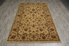 Load image into Gallery viewer, A rectangular area rug with an intricate traditional floral pattern in beige, brown, and muted green, laid out on a gray wood-look floor.