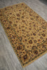 Load image into Gallery viewer, A rectangular vintage-style area rug with an intricate floral and paisley pattern, featuring a warm golden-yellow background and dark brown accents, laid out on a gray wood-look floor.