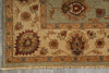 Load image into Gallery viewer, A close-up of a traditional patterned rug corner showing beige, olive green, rust red, and brown floral motifs with a fringed edge on a gray floor.