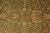 Load image into Gallery viewer, An ornate floral and vine patterned fabric or rug in muted olive green, beige, and rust red tones, shown in a close-up repeating pattern view.