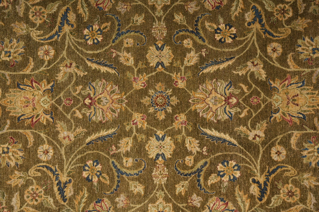 An ornate traditional floral patterned rug with a warm brown and gold base, featuring cream, blue, and pink accents in a symmetrical design.
