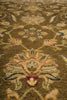 Load image into Gallery viewer, A close-up of an ornate traditional area rug with a floral and vine pattern in olive green, beige, blue, and red.