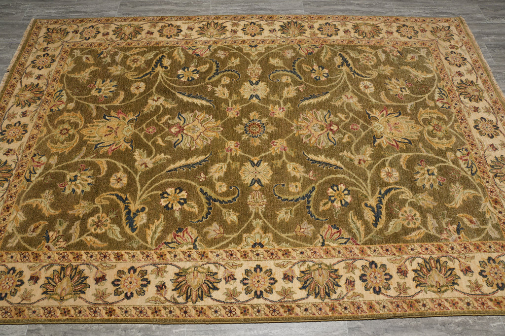 An oriental-style area rug with an intricate floral and vine pattern, featuring a dominant olive green field, beige borders, and accents of blue, red, and yellow.
