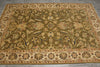 Load image into Gallery viewer, An oriental-style area rug with an intricate floral and vine pattern, featuring a dominant olive green field, beige borders, and accents of blue, red, and yellow.