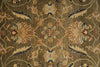 Load image into Gallery viewer, A close-up of an ornate floral patterned rug with a warm brown and beige base, featuring cream, mustard, and navy blue details.