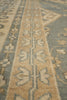 Load image into Gallery viewer, Close-up of a patterned area rug with a beige and slate blue floral design.
