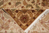 Load image into Gallery viewer, A close-up of a patterned area rug with cream, tan, brown, and muted green floral motifs and white fringe along one corner.