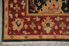 Load image into Gallery viewer, Close-up of a traditional patterned rug corner showing a deep red field with cream floral motifs, a beige border, and dark green accents, with cream fringe visible at the bottom.