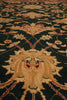 Load image into Gallery viewer, A close-up of a traditional patterned area rug with a dark green background, beige central medallion, and red and gold floral details.