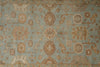 Load image into Gallery viewer, A close-up of a traditional patterned rug with a dusty blue-gray background and warm brown, beige, and muted gold motifs.