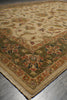 Load image into Gallery viewer, A traditional oriental-style area rug with a beige center field, green border, and multicolored floral motifs, shown laid out on a gray floor.