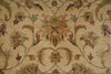 Load image into Gallery viewer, Close-up of a traditional floral patterned rug with a beige background and multicolored motifs in muted green, rust red, and blue.