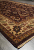 Load image into Gallery viewer, A close-up view of an oriental area rug with a traditional floral pattern, featuring a dark brown border, beige center, and red, green, and blue accents.