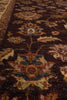 Load image into Gallery viewer, Close-up of a traditional patterned rug with a dark brown background and floral motifs in beige, green, and rust tones.