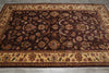 Load image into Gallery viewer, A rectangular traditional area rug with an intricate floral and vine pattern, featuring a dark brown center field and beige borders, laid out on a gray tiled floor.