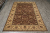 Load image into Gallery viewer, A rectangular area rug with an ornate traditional pattern, featuring a dark brown center field, a beige border, and accents of red and green.