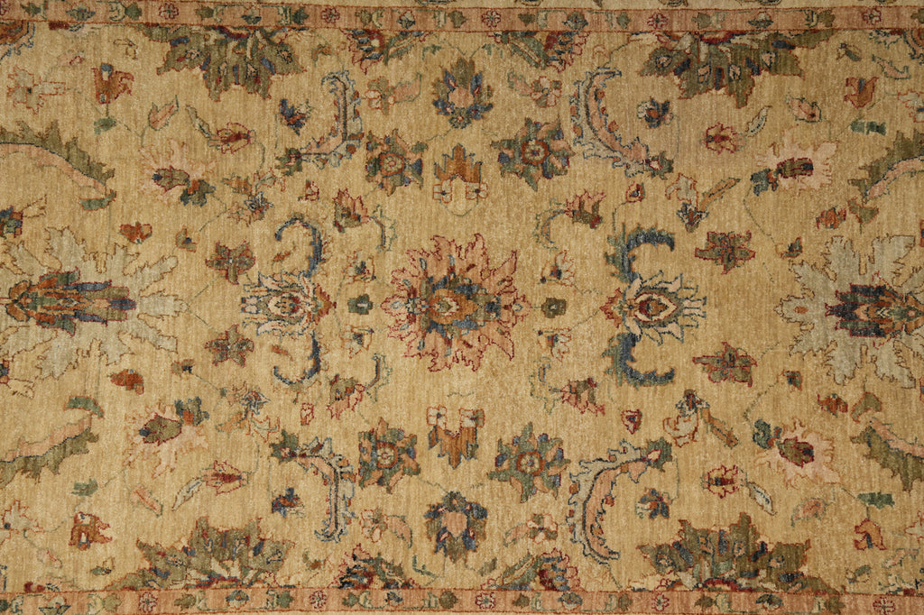 An antique-style oriental rug with a beige background and intricate floral motifs in muted blue, rust red, and brown.