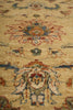 Load image into Gallery viewer, A close-up of a traditional patterned rug with a beige base and intricate floral motifs in red, blue, and brown.