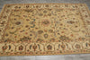 Load image into Gallery viewer, A rectangular vintage-style area rug with an ornate floral and medallion pattern, featuring a warm beige base with accents of rust red, blue, and green, laid out on a gray tiled floor.