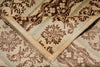 Load image into Gallery viewer, A close-up of a folded patterned textile, likely a rug or blanket, showing a cream base with brown floral motifs and muted blue-green stripe accents.