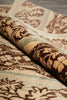Load image into Gallery viewer, A close-up of a rolled area rug showing its detailed pattern. The rug features a complex design with dark brown motifs on a cream background, accented with light blue-green stripes.