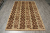 Load image into Gallery viewer, A rectangular area rug with a traditional floral pattern in vertical stripes, featuring a beige base with dark brown and black motifs, shown on a gray wood-look floor.