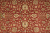 Load image into Gallery viewer, A close-up of a traditional patterned rug with a warm rust-red background and beige, cream, and muted green floral motifs.