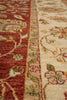 Load image into Gallery viewer, Close-up of a traditional patterned rug with a deep red upper section, a beige border band, and an off-white lower section, all decorated with floral and vine motifs in muted green, yellow, and rust tones.
