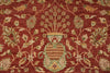 Load image into Gallery viewer, A close-up of a traditional patterned rug featuring a deep red background with beige, green, and gold floral motifs and a central decorative medallion.