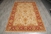 Load image into Gallery viewer, A rectangular traditional area rug with a cream center and red borders, featuring intricate floral and vine patterns in gold and red tones, laid out on a gray wood-look floor.
