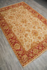 Load image into Gallery viewer, A rectangular traditional area rug with an ornate floral pattern, featuring a cream center field and deep red borders, laid out diagonally on a gray wood-look floor.