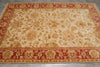 Load image into Gallery viewer, A rectangular area rug with an ornate floral and vine pattern, featuring a cream center field and deep red borders.