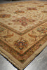 Load image into Gallery viewer, A close-up view of a traditional oriental rug with a beige base and intricate floral patterns in muted red, green, and brown tones, shown on a gray floor.