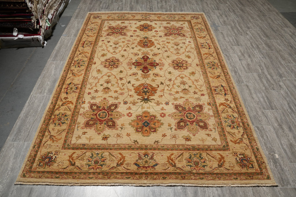 A rectangular traditional area rug with an ornate floral and medallion pattern, displayed on a gray wood-look floor.