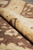 Load image into Gallery viewer, Close-up of a rolled area rug showing its beige and brown floral pattern.