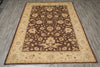 Load image into Gallery viewer, A rectangular area rug with an ornate floral pattern, featuring a dark brown center field surrounded by beige and brown borders, laid out on a gray wood-look floor.