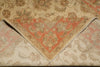 Load image into Gallery viewer, A close-up of a folded vintage-style area rug showing its intricate floral and geometric patterns in beige, rust red, and muted green.