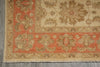 Load image into Gallery viewer, A close-up of a traditional patterned rug corner, showing a warm rust-red field, beige border, and muted green and tan floral motifs on a gray floor.