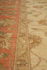 Load image into Gallery viewer, Close-up of a patterned area rug showing a rust red upper border, a beige central band, and a cream lower section with floral motifs.