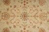 Load image into Gallery viewer, A close-up of a traditional patterned rug with a central floral medallion and symmetrical scrollwork in muted beige, rust, and dusty pink tones.