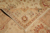 Load image into Gallery viewer, A close-up of a traditional oriental-style area rug with a folded corner showing its beige base and multicolor floral and geometric patterns.