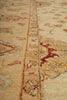 Load image into Gallery viewer, Close-up of an ornate patterned area rug with a beige and cream base and red, brown, and muted blue floral motifs.