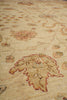 Load image into Gallery viewer, Close-up of a beige patterned rug with floral and scroll motifs in muted red, tan, and brown tones.