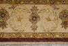Load image into Gallery viewer, Close-up of a traditional patterned rug with a central floral medallion, scrolling motifs, floral corners, and a dark burgundy border with fringe.