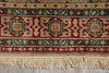 Load image into Gallery viewer, A close-up of a patterned area rug with a cream fringe, featuring red, teal, and beige geometric motifs.